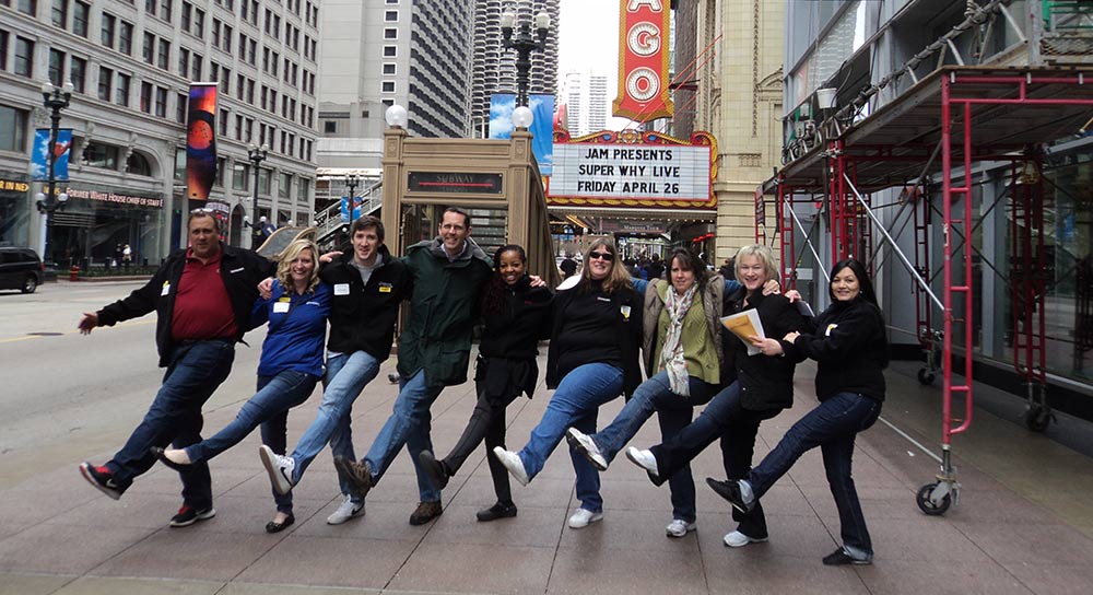 great amazing race - teams posing in a kick line in front of the chicago theater