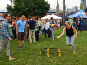 Guests playing spikeball at their company picnic at UIC Picnic Grounds