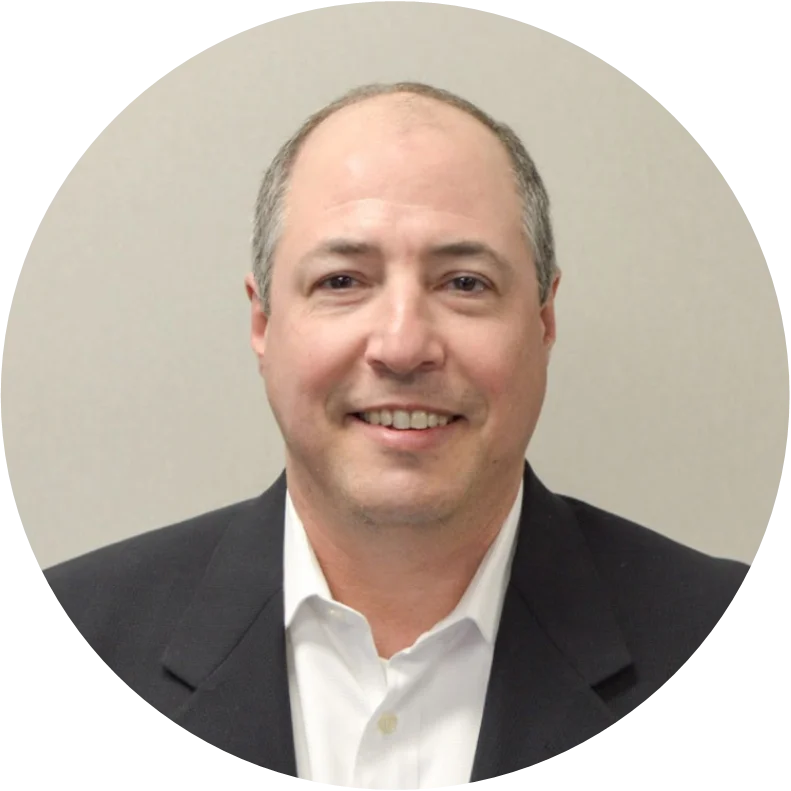 Man in suit against neutral background.