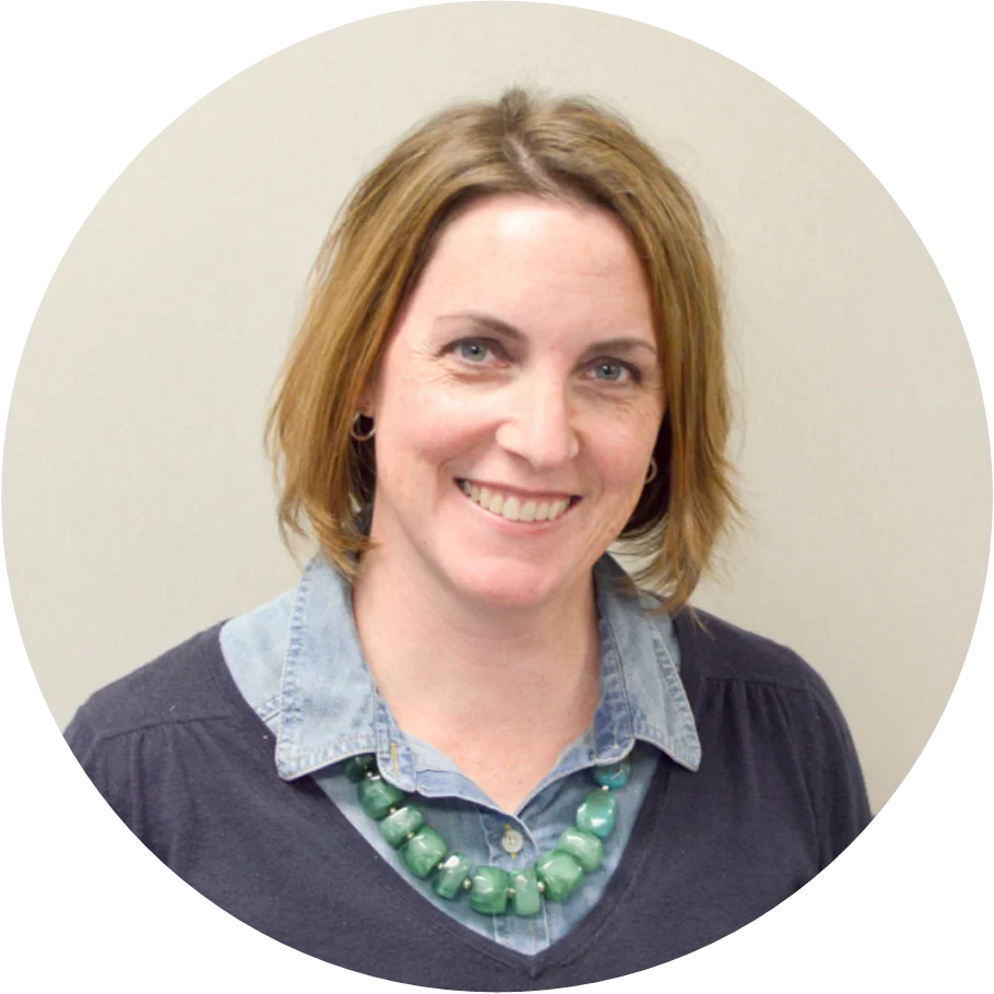 Person with necklace and denim shirt