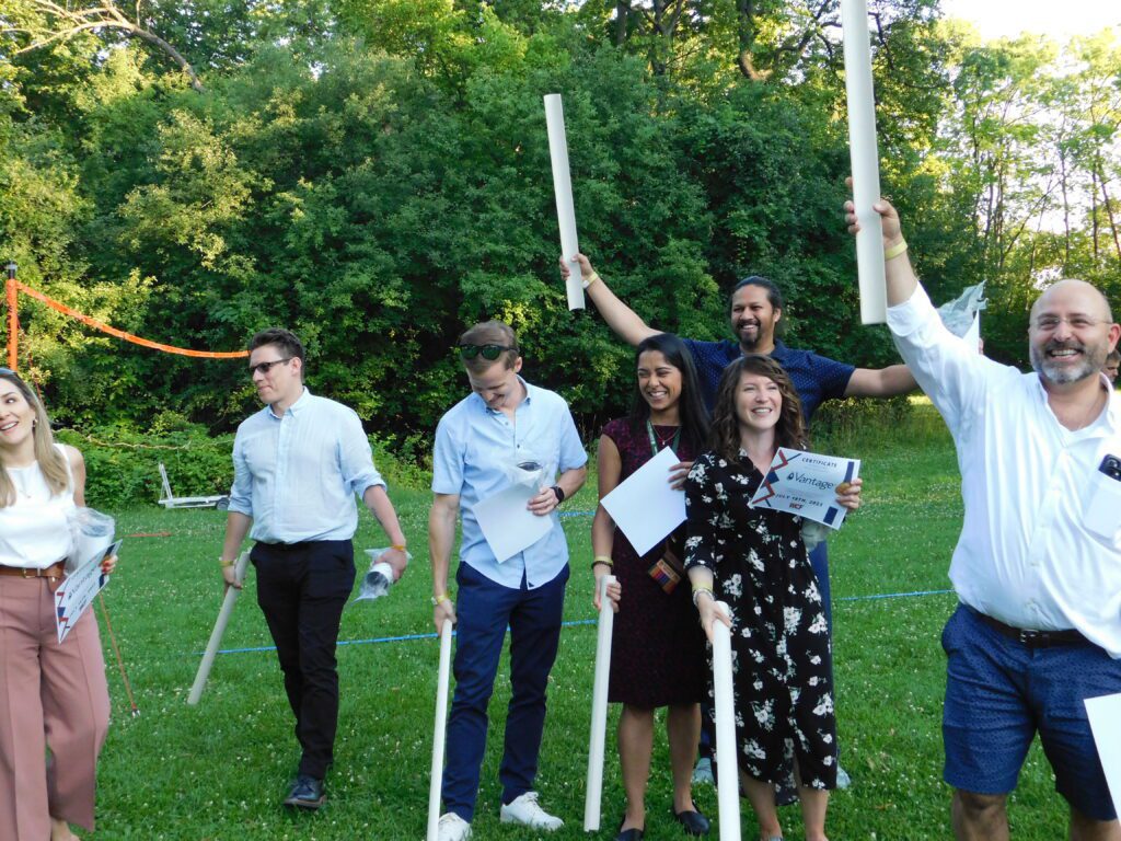 Guests celebrating after completing a team building activity at their summer outing