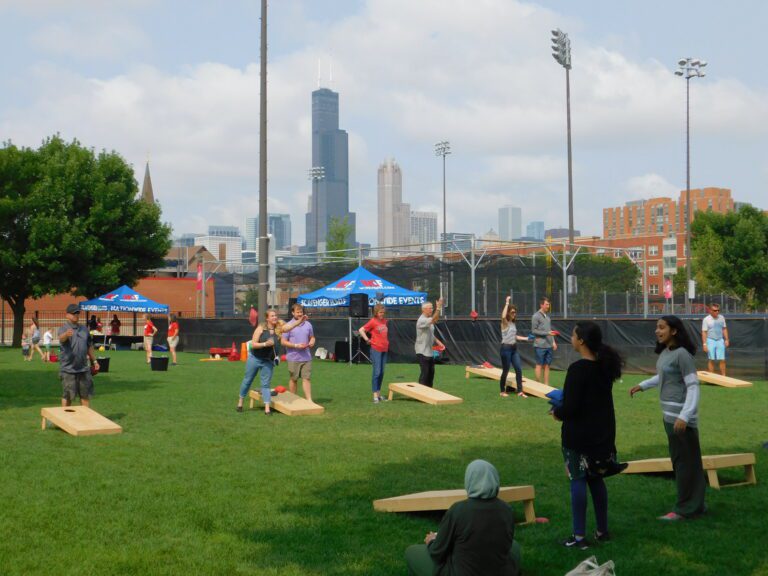 Shot of guests playing baggo at UIC Picnic Grounds with the skyline in the background